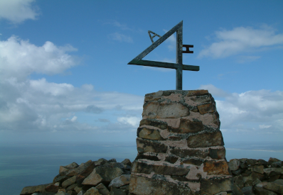 A photo of the trig point at the summit of Yr Eifl.